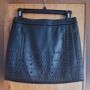 BCBGMaxAzria new "Remi" overlapping eyelet faux leather miniskirt.